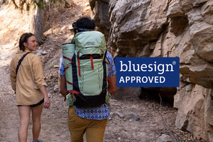 Couple walking through the forest carrying talon 33 hiking backpack - Bluesign Approved