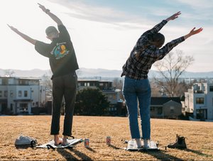 two people doing some yoga and stretching while standing on their crazy creek chairs