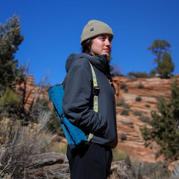 Woman using the strap on strap to carry her hex chair