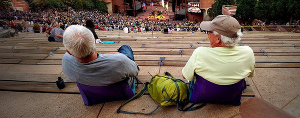 woman in crazy creek at red rocks concert