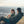 Two people laughing and talking sitting in chairs on the top of a mountain at sunset
