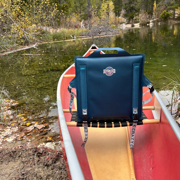 Blue paddle chair strapped onto a canoe