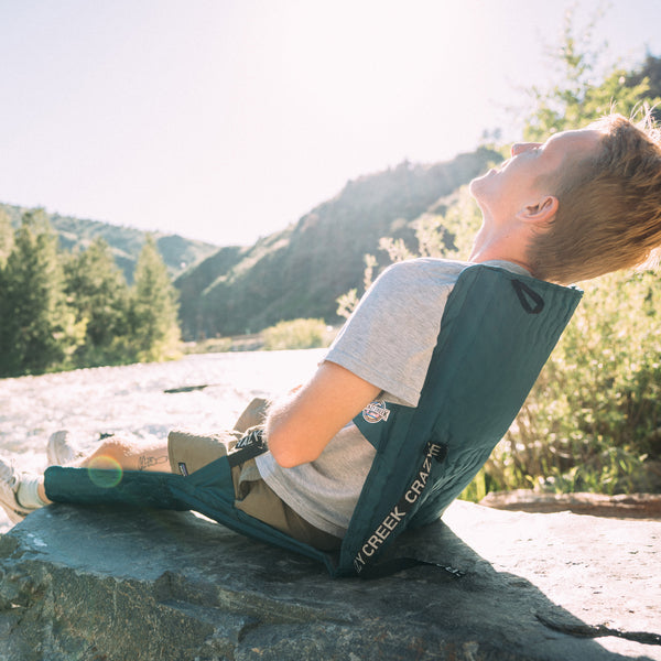 Man Lounging in Crazy Creek chair